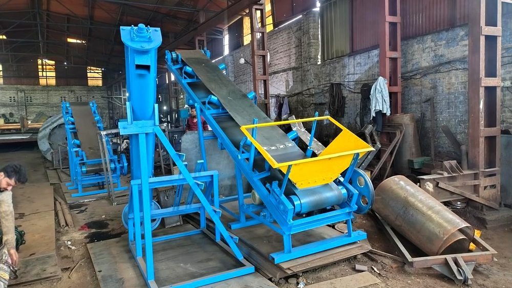 Anand Organics conveyor systems in the workshop — screw and incline belt conveyors